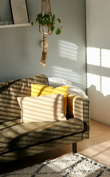 Yellow upholstered armchair on a wood floor